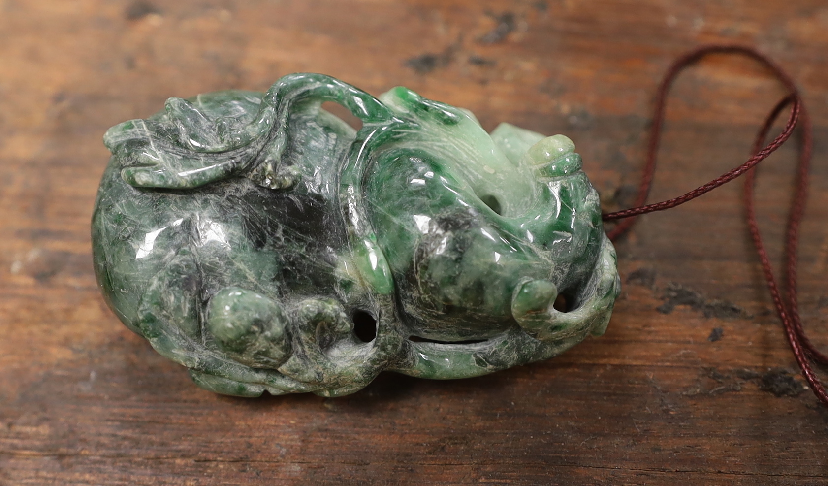 Five Chinese jadeite pendants and two wood lion-dog netsuke, netsuke 3.5 high